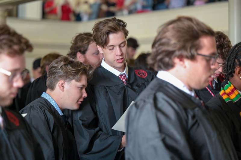 a group of people in black robes