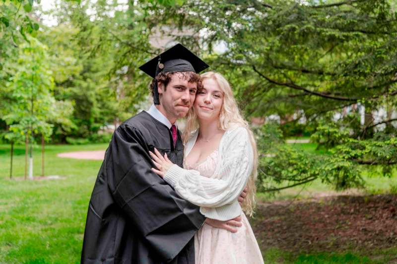 a man and woman in graduation gowns and cap and gown