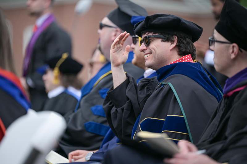a man in a graduation gown and cap