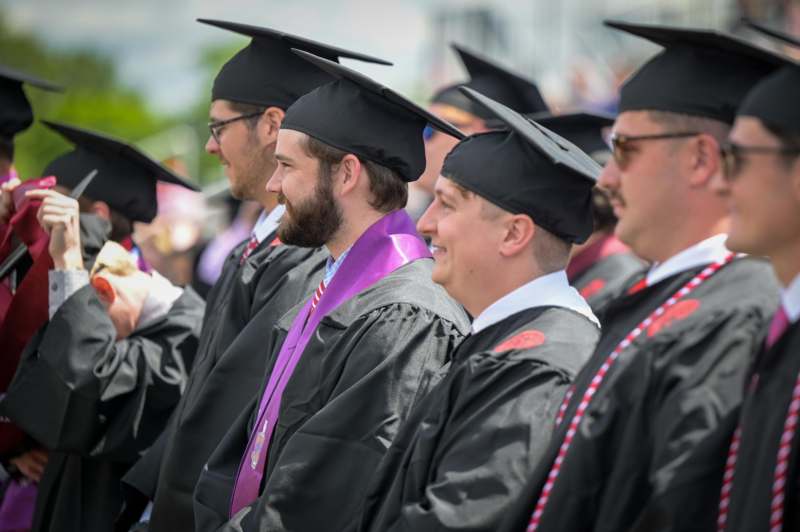 a group of men in graduation gowns