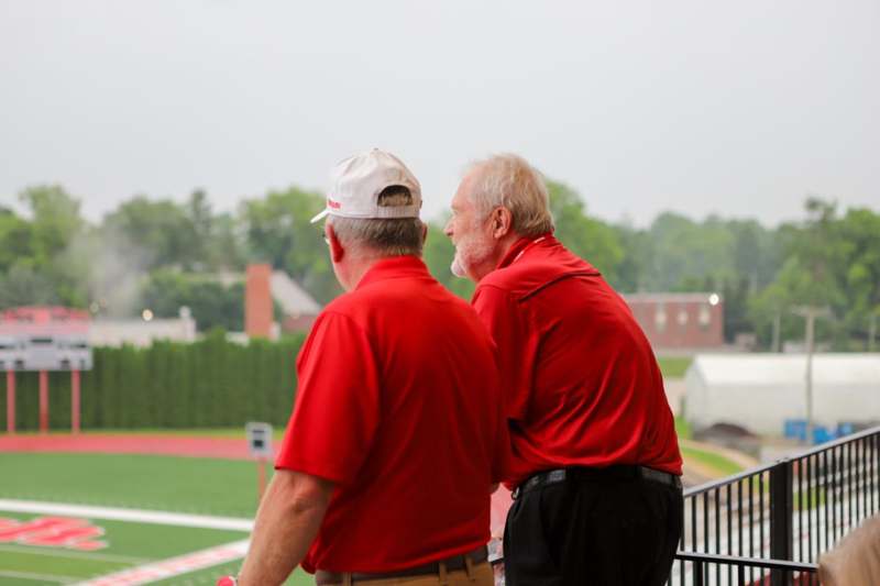 two men in red shirts