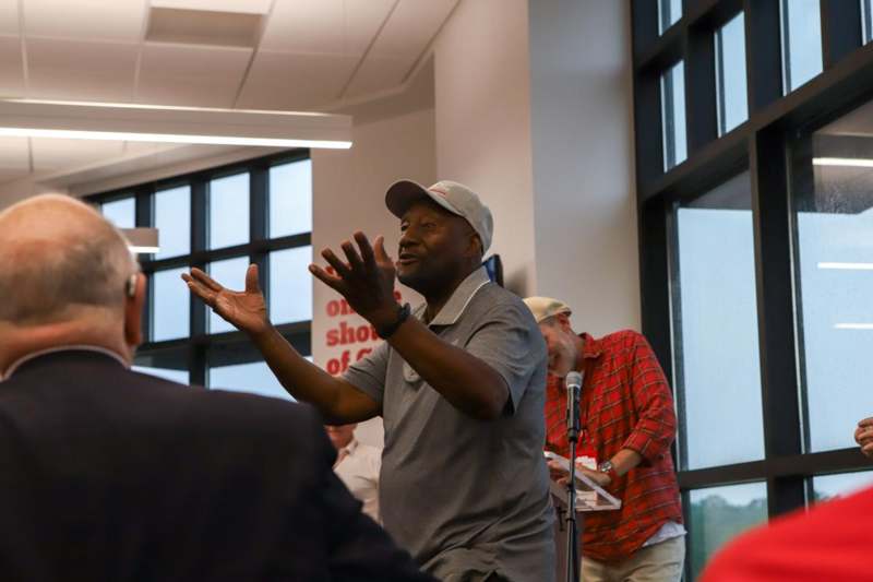 a man in a cap speaking into a microphone