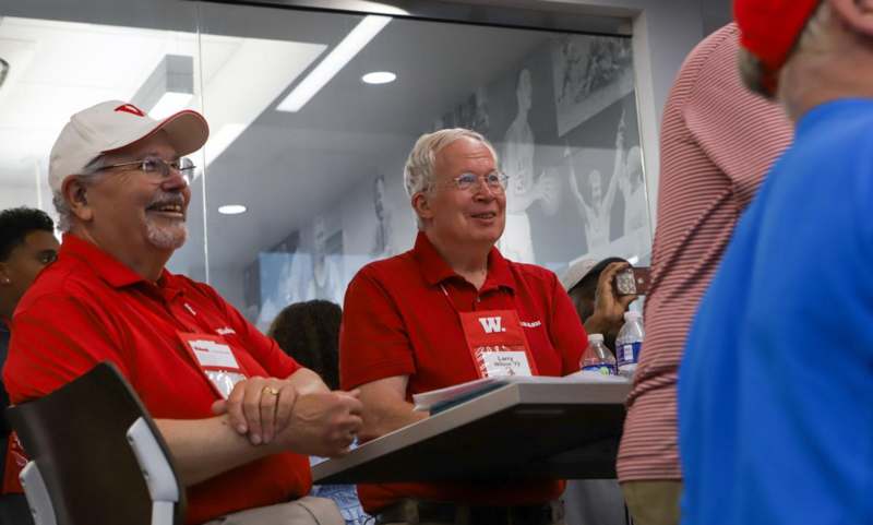 a group of men in red shirts