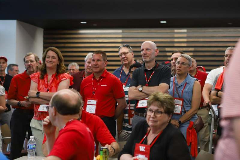 a group of people wearing red lanyards