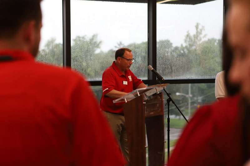 a man standing at a podium with a microphone