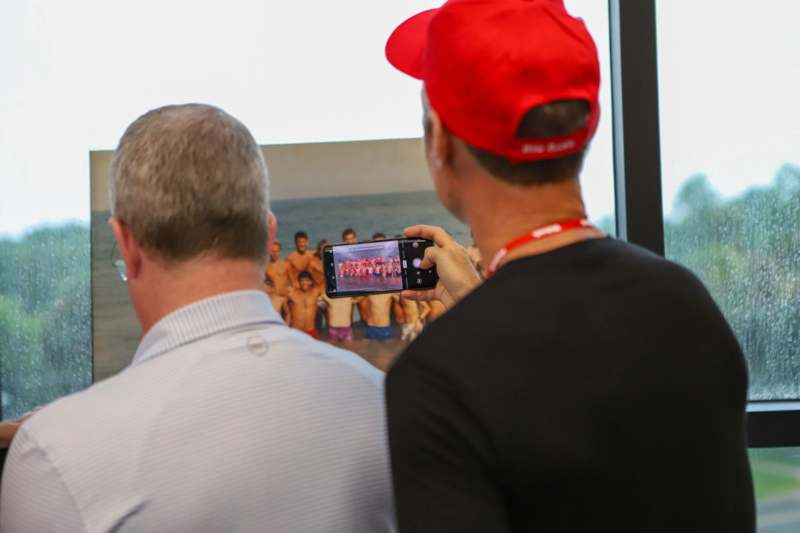 a man taking a picture of a group of men