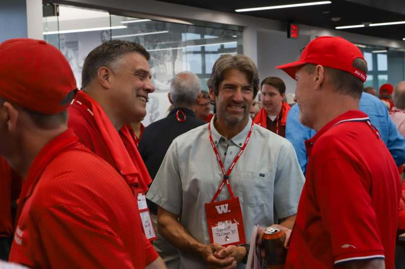 a group of men wearing red shirts and badges