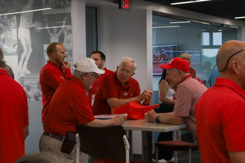 a group of men in red shirts