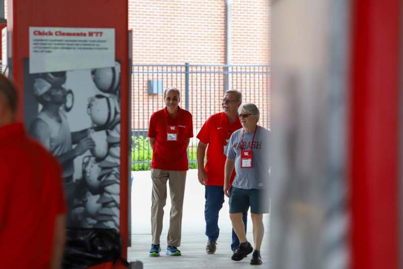 a group of people walking down a walkway