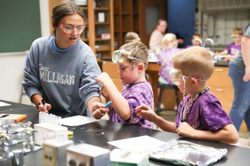 a woman and kids in a lab