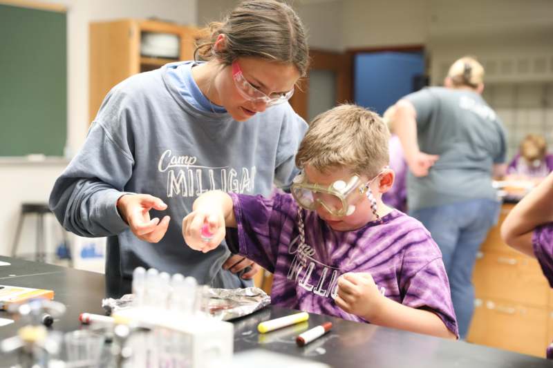 a woman and a boy wearing safety goggles