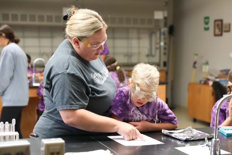 a woman and a child wearing safety goggles