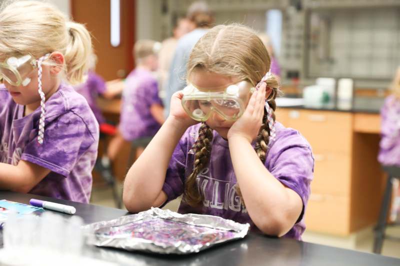 a girl wearing goggles and looking at something