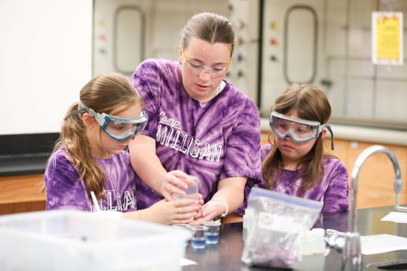 a group of girls wearing safety goggles and standing next to each other