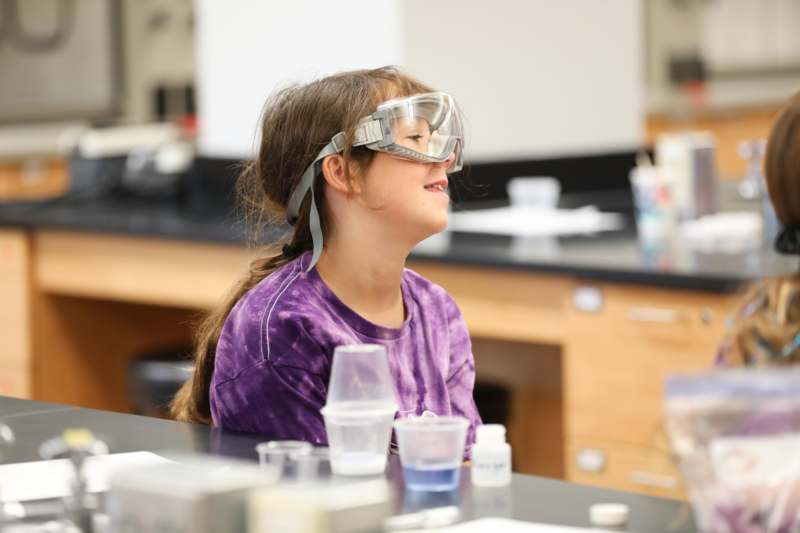 a girl wearing goggles in a lab