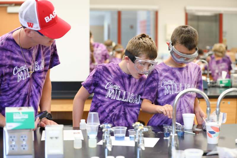 a group of kids wearing goggles and standing in front of a sink