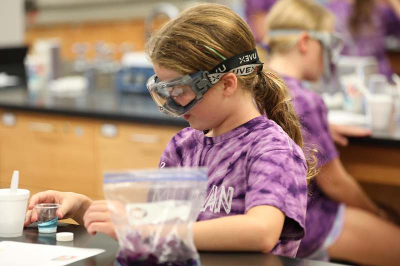 a girl wearing goggles and a bag of liquid