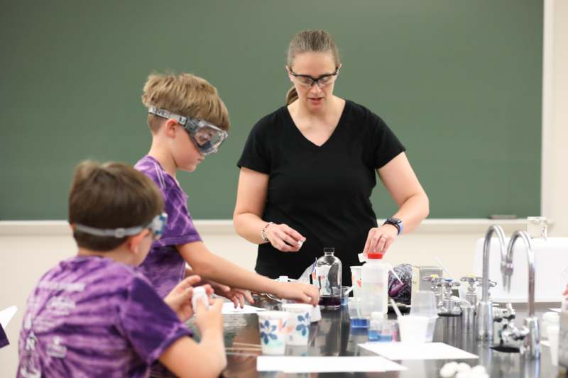 a woman and kids in a classroom