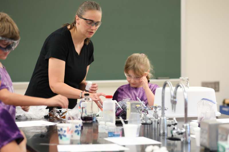 a woman and a girl in a science lab