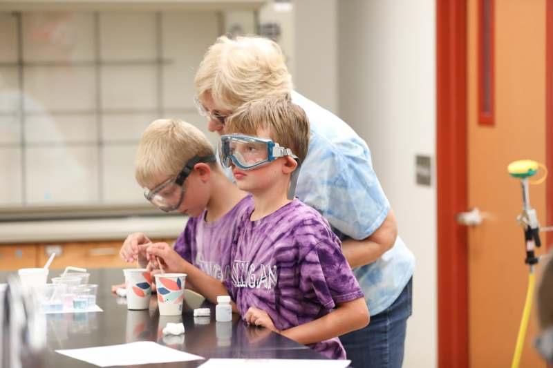 a group of people wearing goggles and standing next to a table