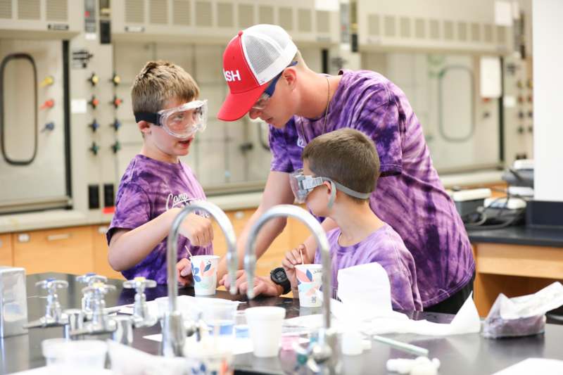 a group of people in purple shirts