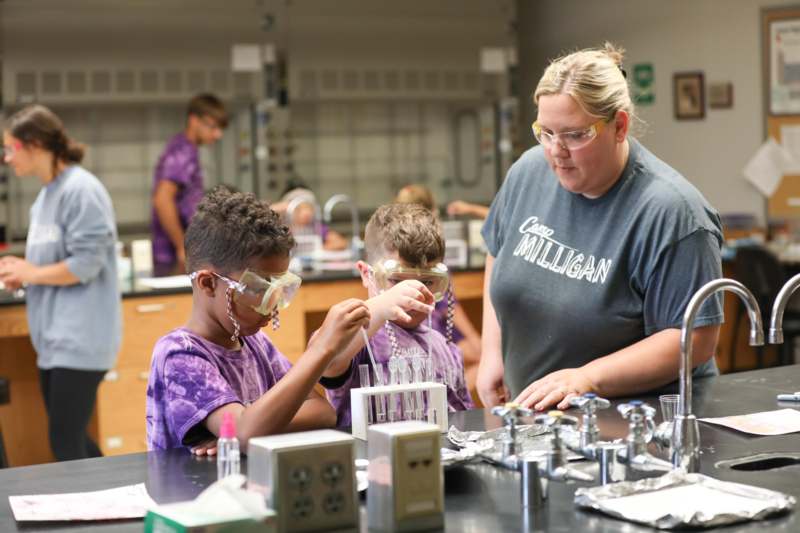 a woman and kids in a lab