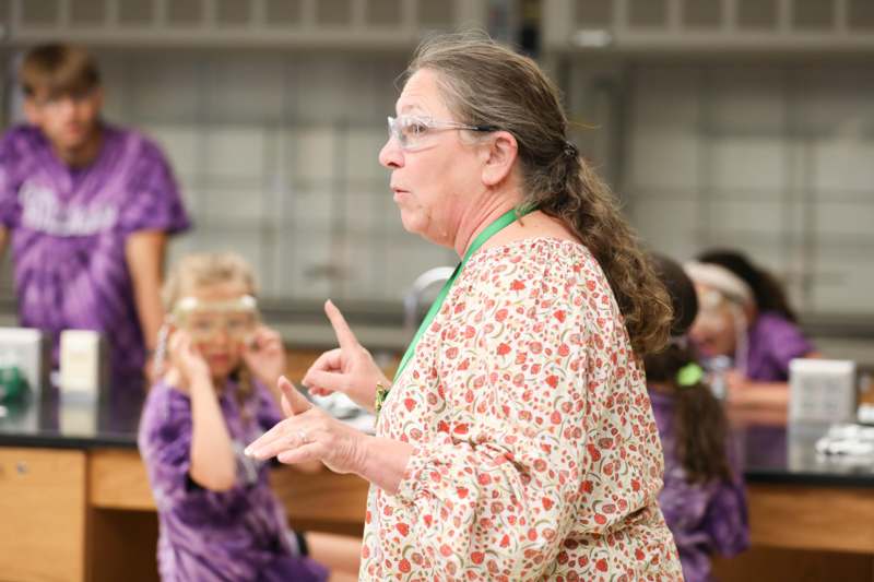 a woman wearing glasses and a floral robe