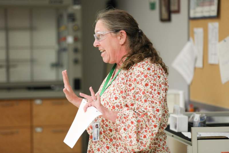 a woman in a floral shirt and goggles
