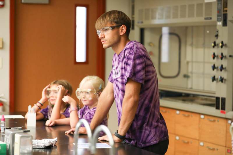 a man and kids in a lab