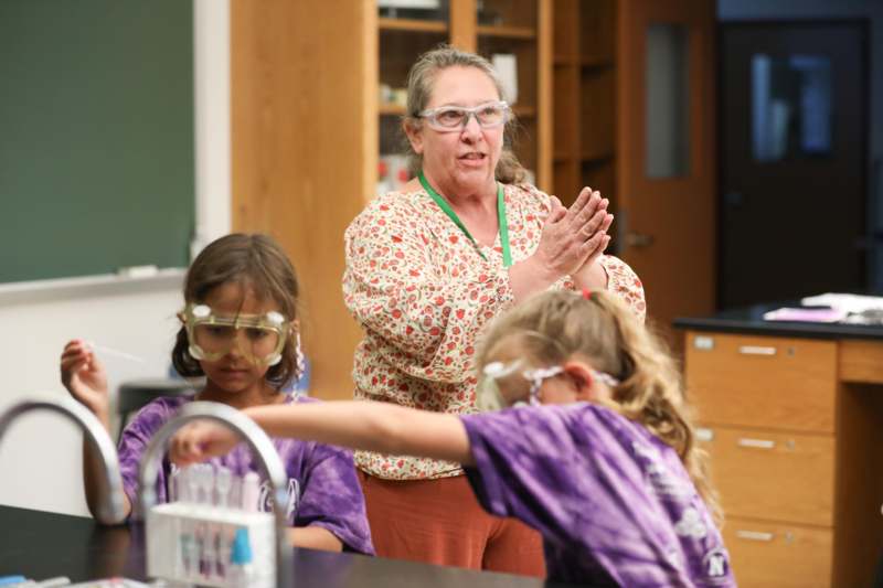 a woman and kids in a lab