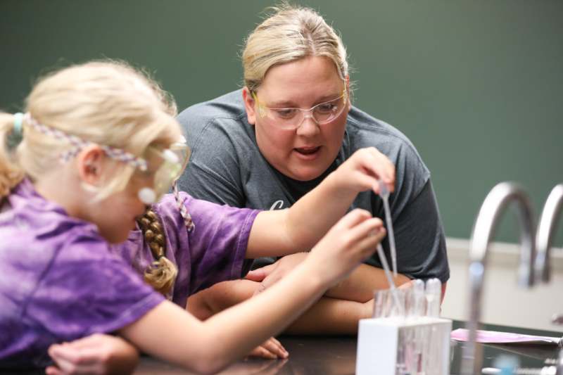 a woman and a girl in safety goggles