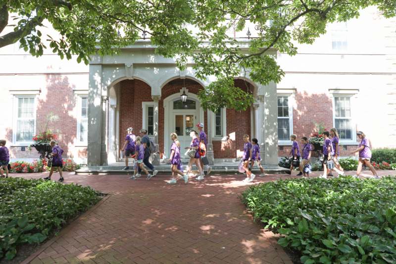 a group of people walking in front of a building