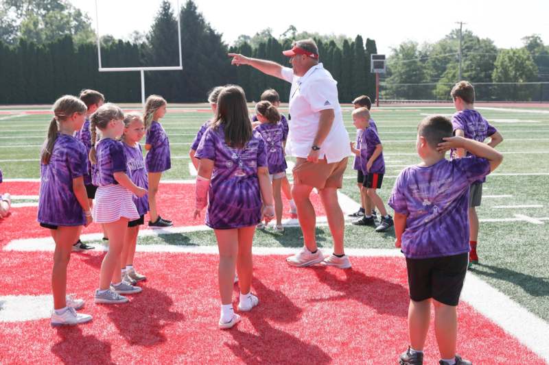 a group of kids on a football field
