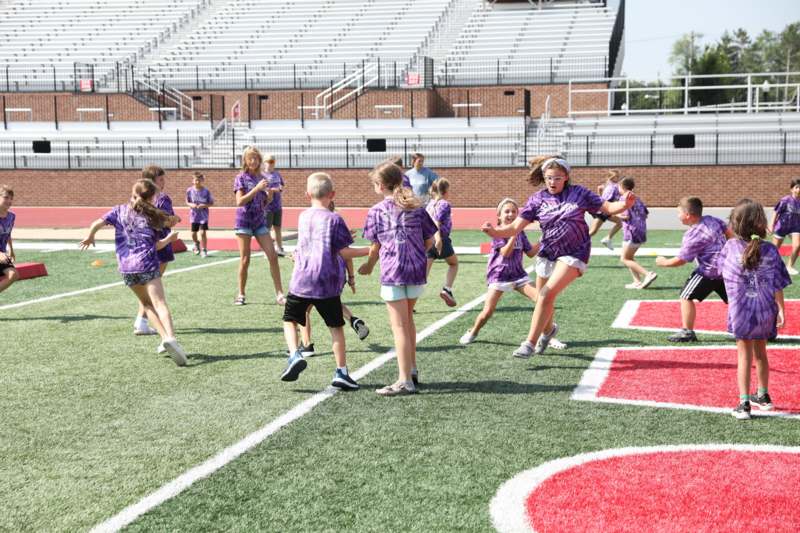 a group of kids playing football on a field