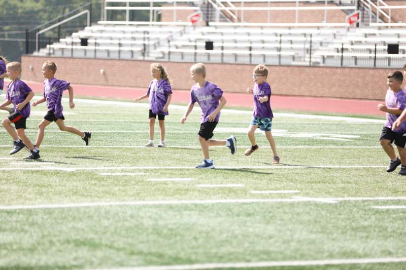a group of kids running on a field