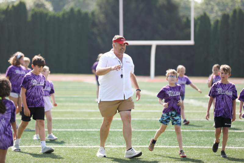 a man and kids on a field