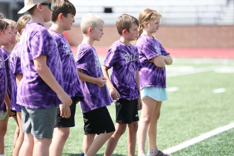 a group of kids standing on a field