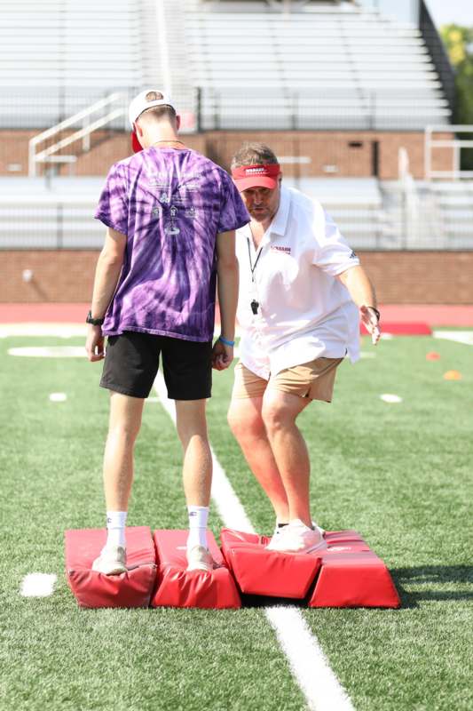 a man standing on a step on a football field