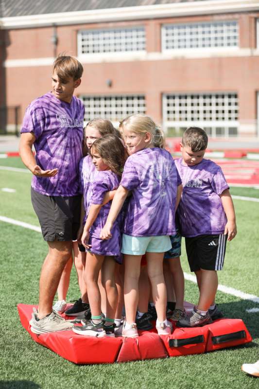a group of kids standing on a platform