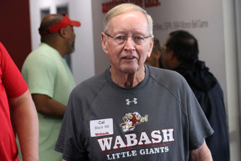 a man wearing glasses and a striped shirt