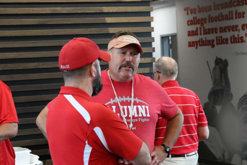 a group of men in red shirts