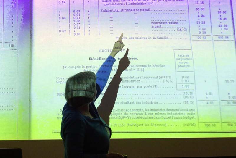 a woman pointing at a projector screen