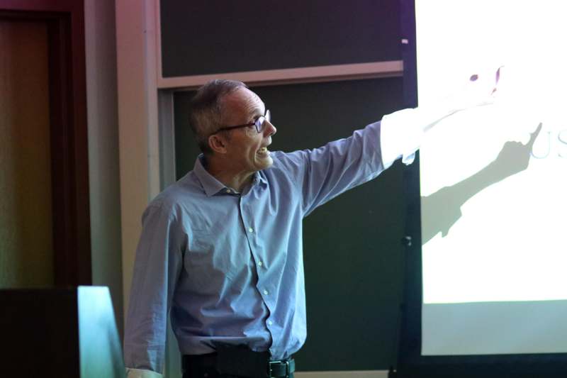 a man pointing at a screen