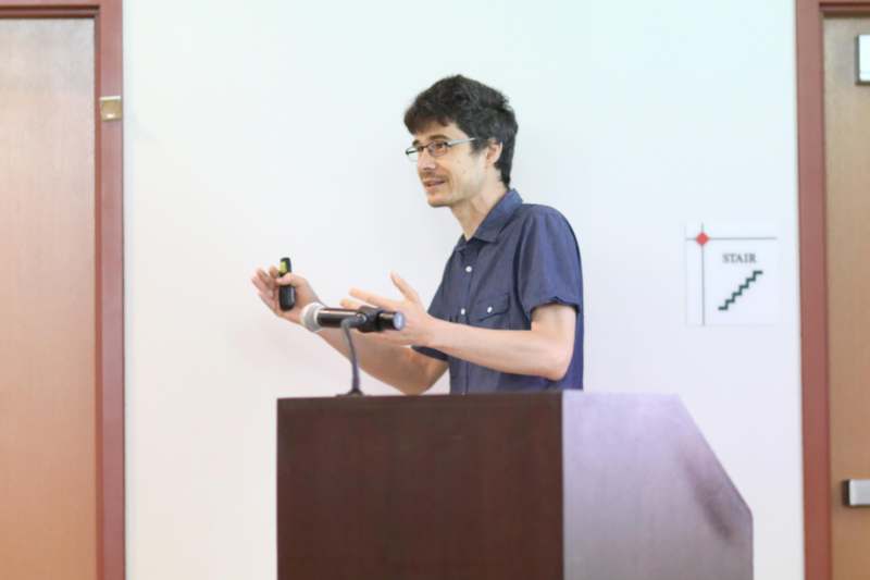 a man standing at a podium holding a microphone
