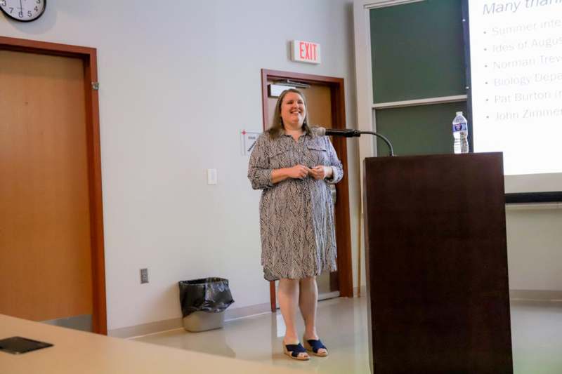 a woman standing in front of a podium