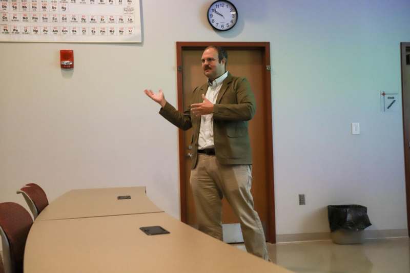 a man standing in front of a table