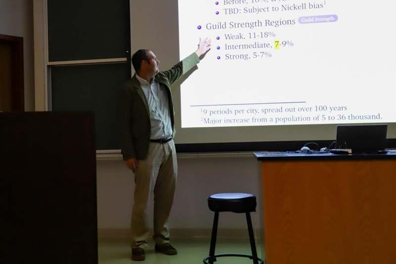 a man standing in front of a projection screen