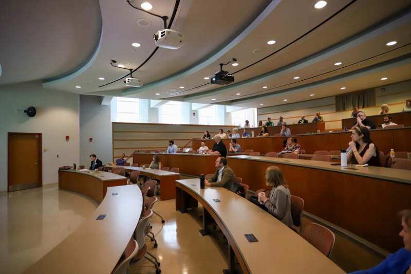 a group of people sitting in a lecture hall