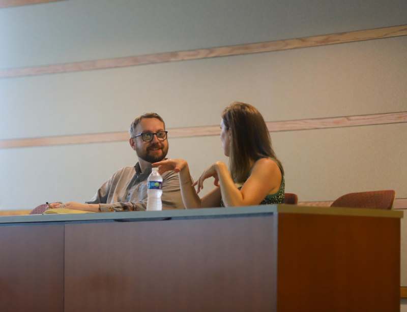 a man and woman sitting at a table