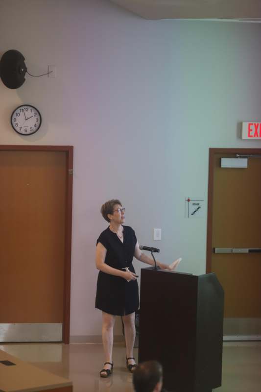 a woman standing at a podium
